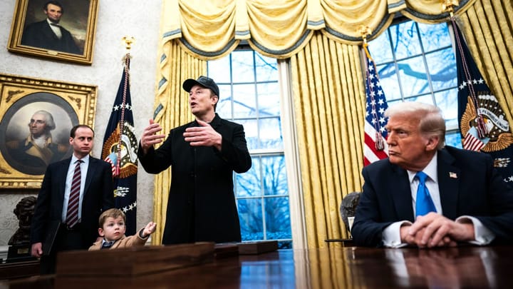 A Trump advisor, Elon Musk and his son X stand in the Oval Office. Trump sits at his desk.